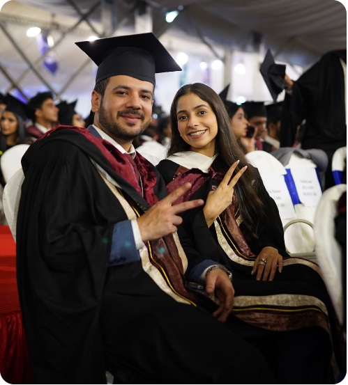 LUMS graduates celebrating at a graduation ceremony